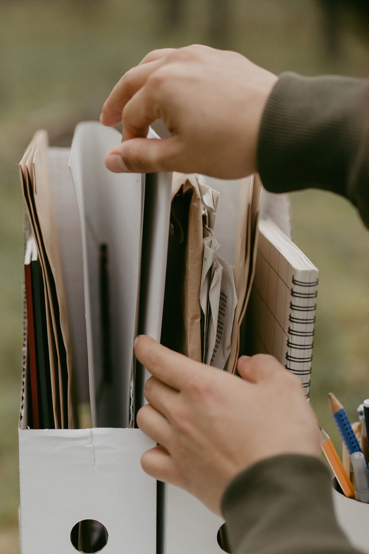 Hands organizing document files and folders