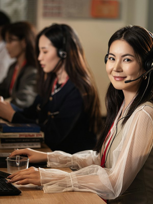 Support agents wearing headsets at a helpdesk