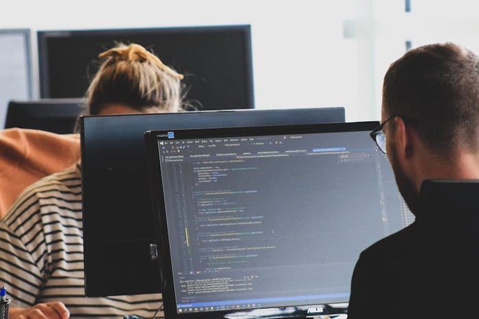 Developers working at a code editor